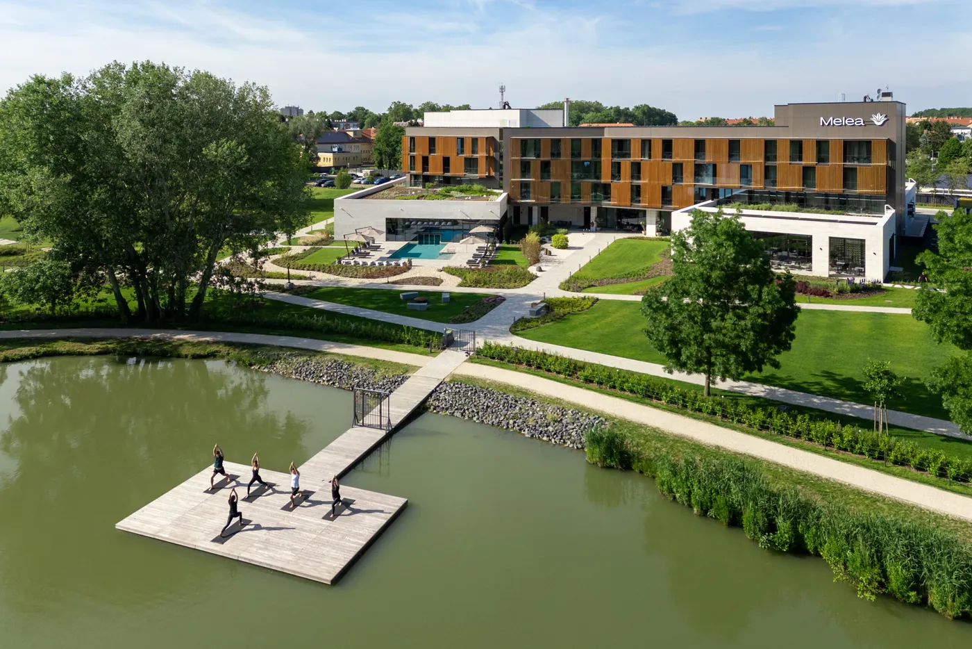 Melea from above: the hotel, its gardens and the lake, with a class on the pier