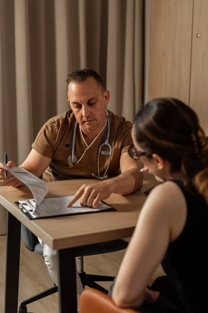 A Melea physician going through results with a guest