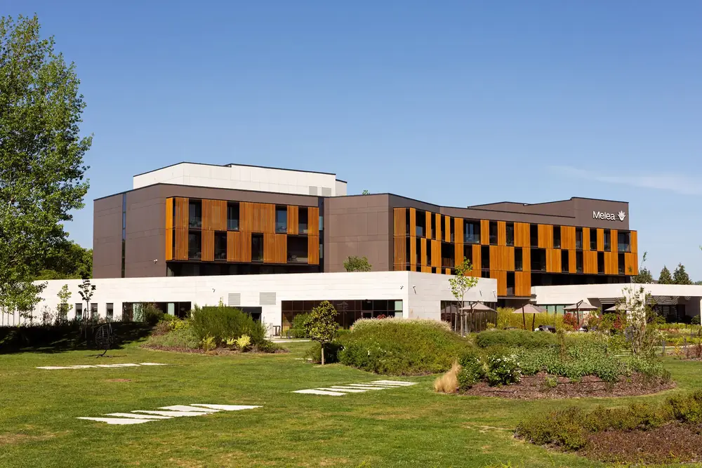 Melea and its gardens under a clear sky